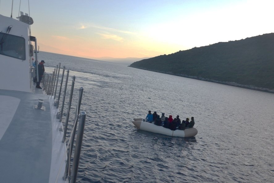 Turkey's coast guard units approach irregular migrants in a boat off the coast of western Aydın province, Turkey, Nov. 9, 2021. (AA Photo)