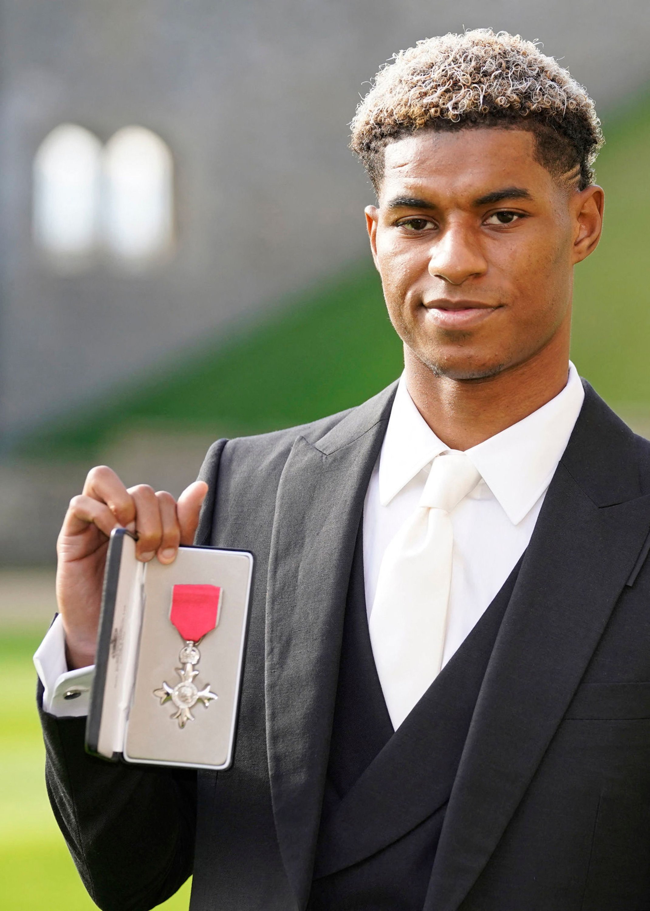 Manchester United and England footballer Marcus Rashford poses with his medal after being appointed a Member of the Order of the British Empire (MBE) at Windsor Castle, London, England, Nov. 9, 2021. (AFP Photo)