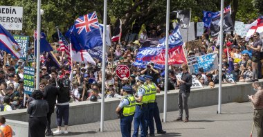 Police watch as the Freedom and Rights Coalition protesters gather at parliament, in Wellington, New Zealand, Nov. 9, 2021. (AP Photo)