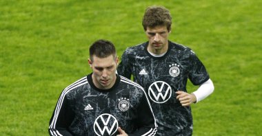 Germany's Niklas Sule and Thomas Muller warmup before 2022 World Cup UEFA qualifier against North Macedonia, Skopje, North Macedonia, Oct. 11, 2021. (Reuters Photo)