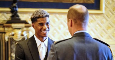 Footballer Marcus Rashford (L) is made an MBE (Member of the Order of the British Empire) by Britain's Prince William during an investiture ceremony at Windsor Castle, England, Nov. 9, 2021. (AP Photo)