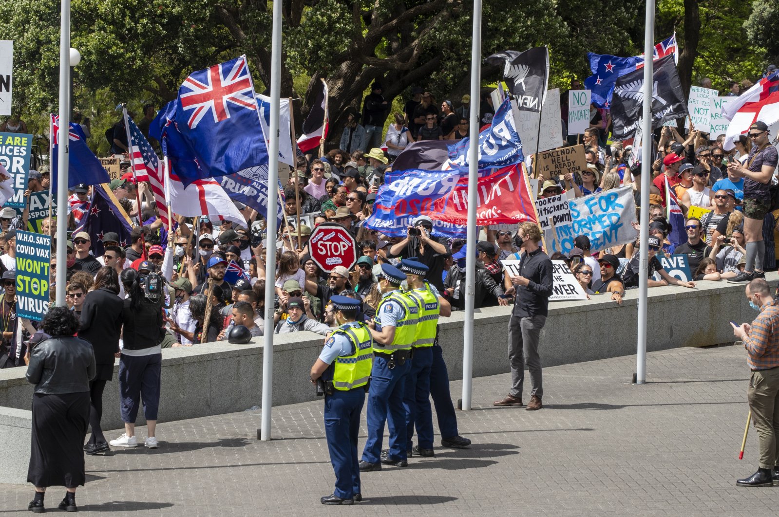 Police watch as the Freedom and Rights Coalition protesters gather at parliament, in Wellington, New Zealand, Nov. 9, 2021. (AP Photo)