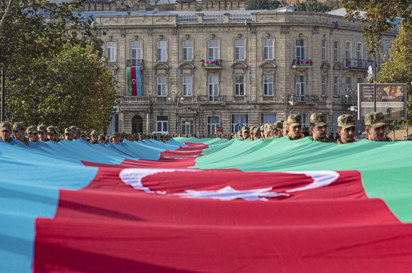 Azerbaijani soldiers carry a large-scale national flag on the anniversary of the end of the 2020 war over the Nagorno-Karabakh region between Azerbaijan and Armenia, in Baku, Azerbaijan, Nov. 8, 2021. (EPA Photo)
