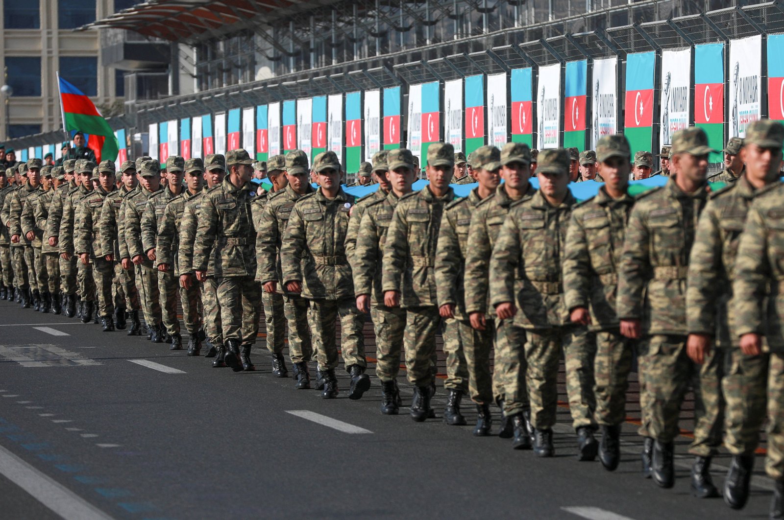 Azerbaijani service members take part in a procession marking the anniversary of the end of the 2020 military conflict over Nagorno-Karabakh region, in Baku, Azerbaijan, Nov. 8, 2021. (REUTERS/Aziz Karimov)