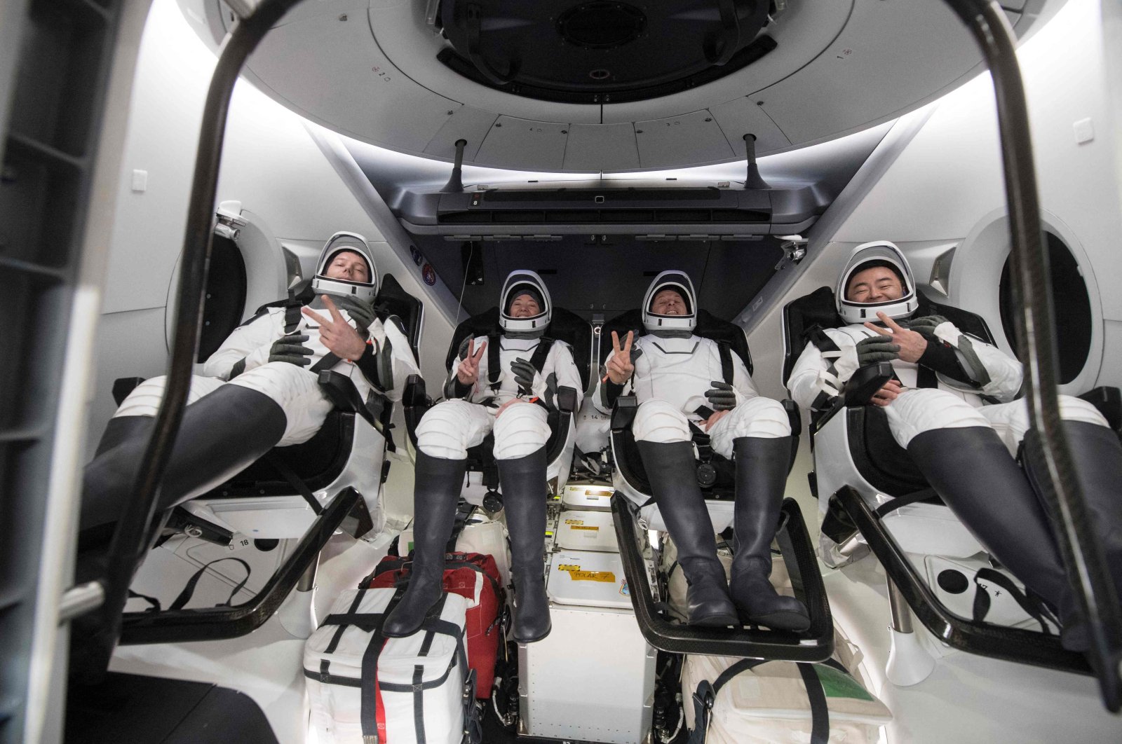 This NASA handout photo shows (from L) ESA (European Space Agency) astronaut Thomas Pesquet, NASA astronauts Megan McArthur and Shane Kimbrough, and Japan Aerospace Exploration Agency (JAXA) astronaut Aki Hoshide, inside the SpaceX Crew Dragon Endeavour spacecraft onboard the SpaceX GO Navigator recovery ship shortly after having landed in the Gulf of Mexico off the coast of Pensacola, United States, Nov. 8, 2021. (Photo by Aubrey GEMIGNANI / NASA via AFP)