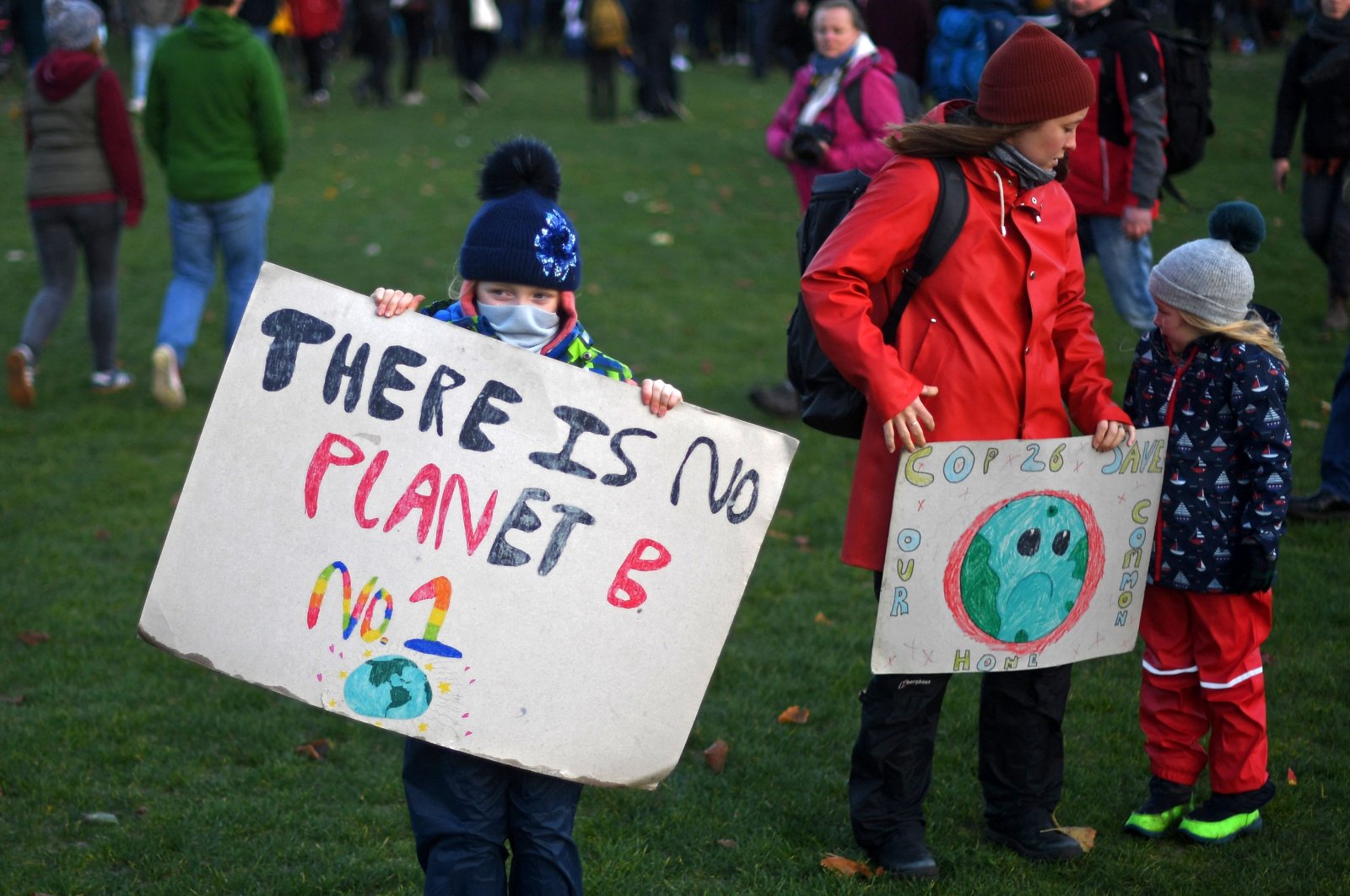A young protester holds up a placard at a protest rally during a global day of action on climate change during the COP26 U.N. Climate Change Conference in Glasgow, United Kingdom, Nov. 6, 2021. (AFP Photo)