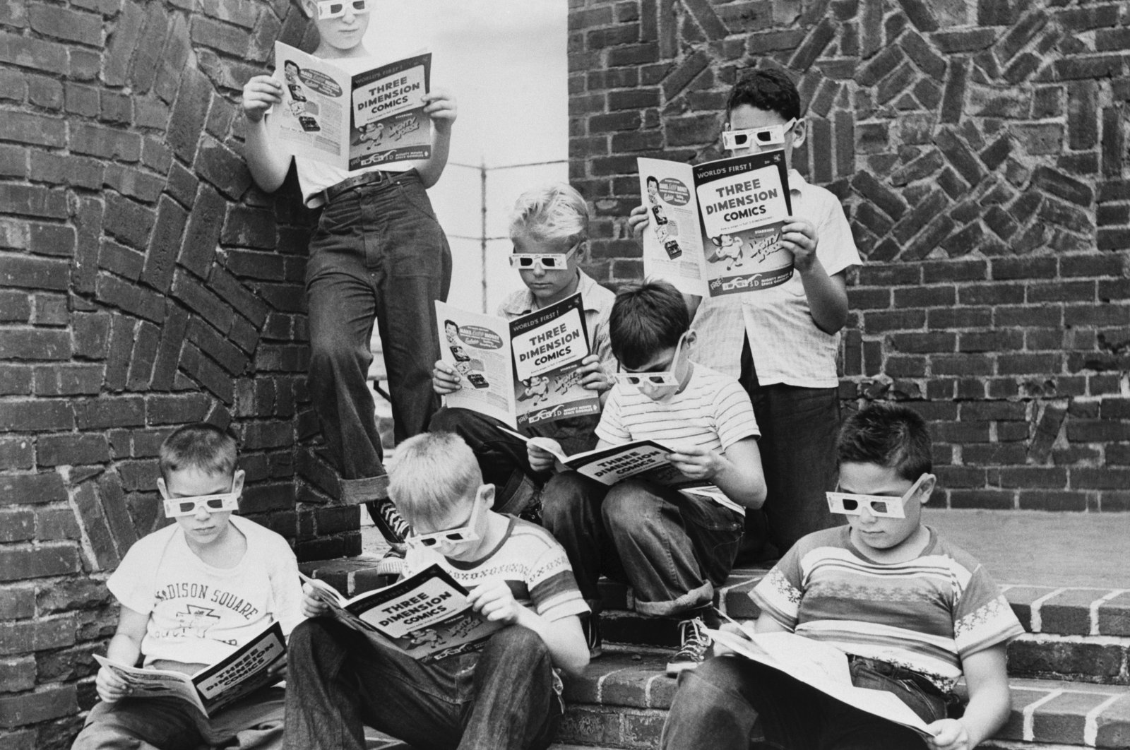 A group of boys read 3-D comic books at the Madison Square Boys Club, New York, United States. (Getty Images)
