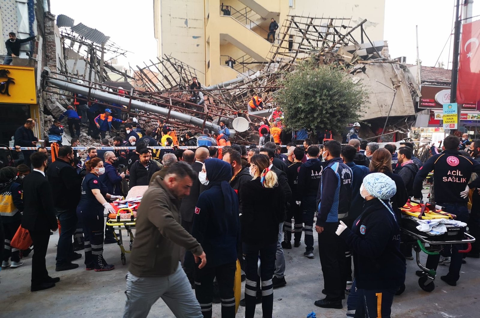 Search and rescue personnel and citizens are seen in front of a collapsed building in Malatya, eastern Turkey, Nov. 9, 2021. (DHA Photo)