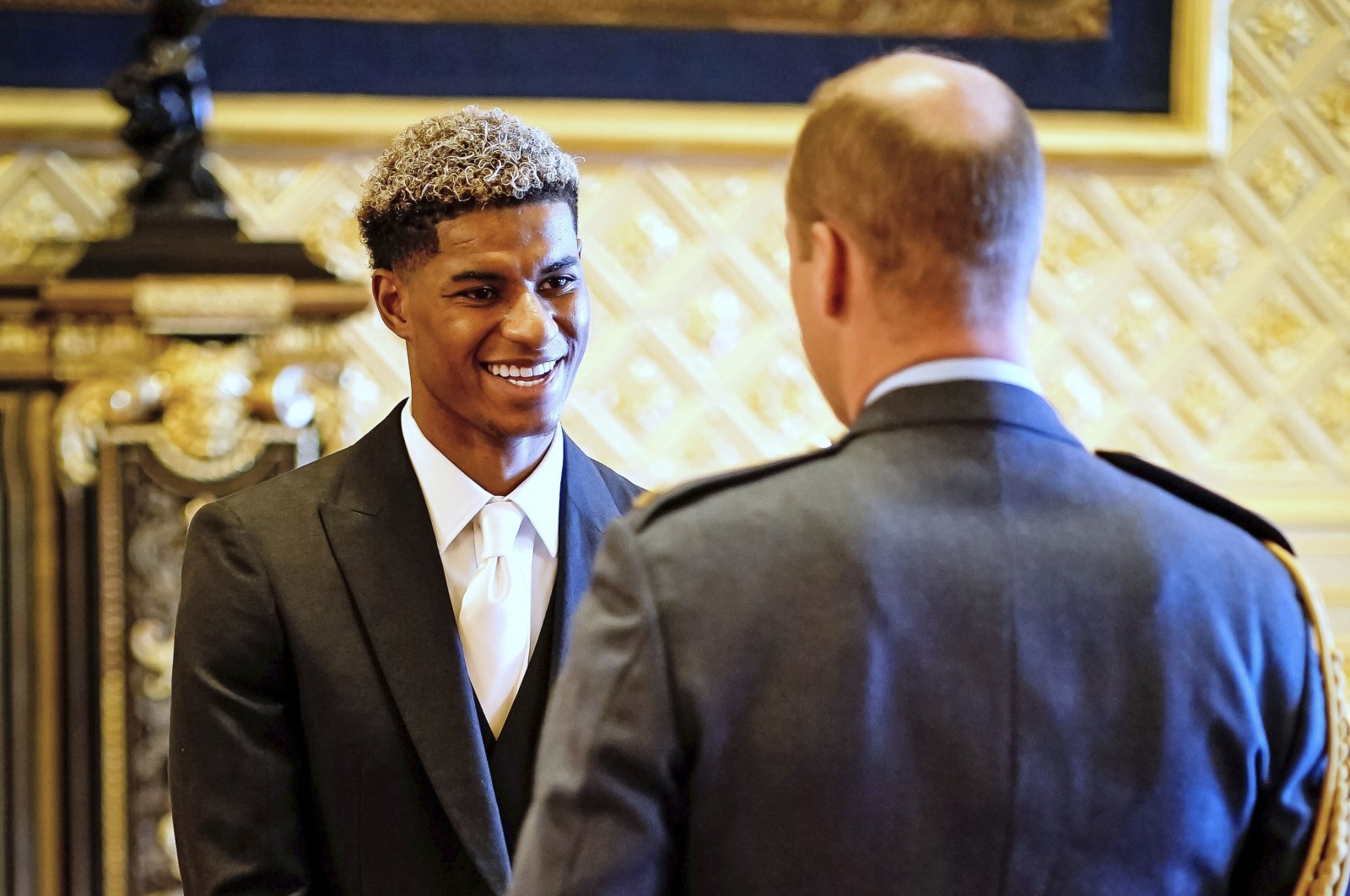 Footballer Marcus Rashford (L) is made an MBE (Member of the Order of the British Empire) by Britain's Prince William during an investiture ceremony at Windsor Castle, England, Nov. 9, 2021. (AP Photo)