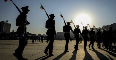 Ethiopian military parade with national flags attached to their rifles at a rally organized by local authorities to show support for the Ethiopian National Defense Force (ENDF), at Meskel square in downtown Addis Ababa, Ethiopia, Nov. 7, 2021. (AP Photo)