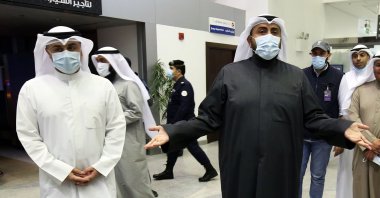 Kuwaiti Health Minister Sheikh Basel Al Sabah (R) speaks to the press at Sheikh Saad Airport in Kuwait City, Kuwait, Feb. 22, 2020.  (AFP Photo)