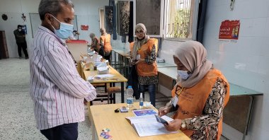 A Libyan man registers to vote inside a polling station in Tripoli, Libya, Nov. 8, 2021. (AFP Photo)