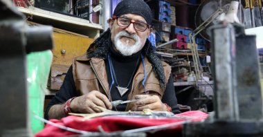 Erdoğan Güzel, maker of world's smallest knives, poses for a photo in his workshop, in Sivas, Turkey, Nov. 10, 2021. (IHA Photo)