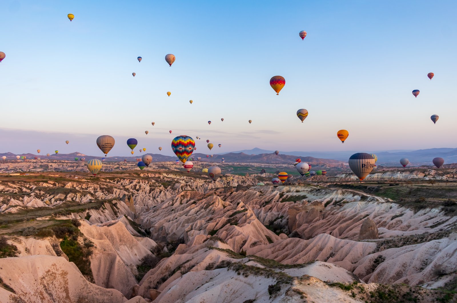 Hot air balloons dot the sky in Cappadocia, Turkey. (Shutterstock Photo)