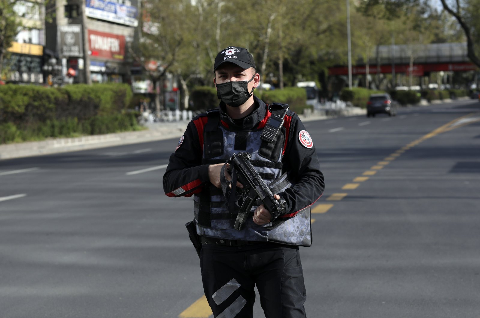 A police officer secures the area on a deserted main road in Ankara, Turkey, Friday, April 30, 2021. (AP File Photo)