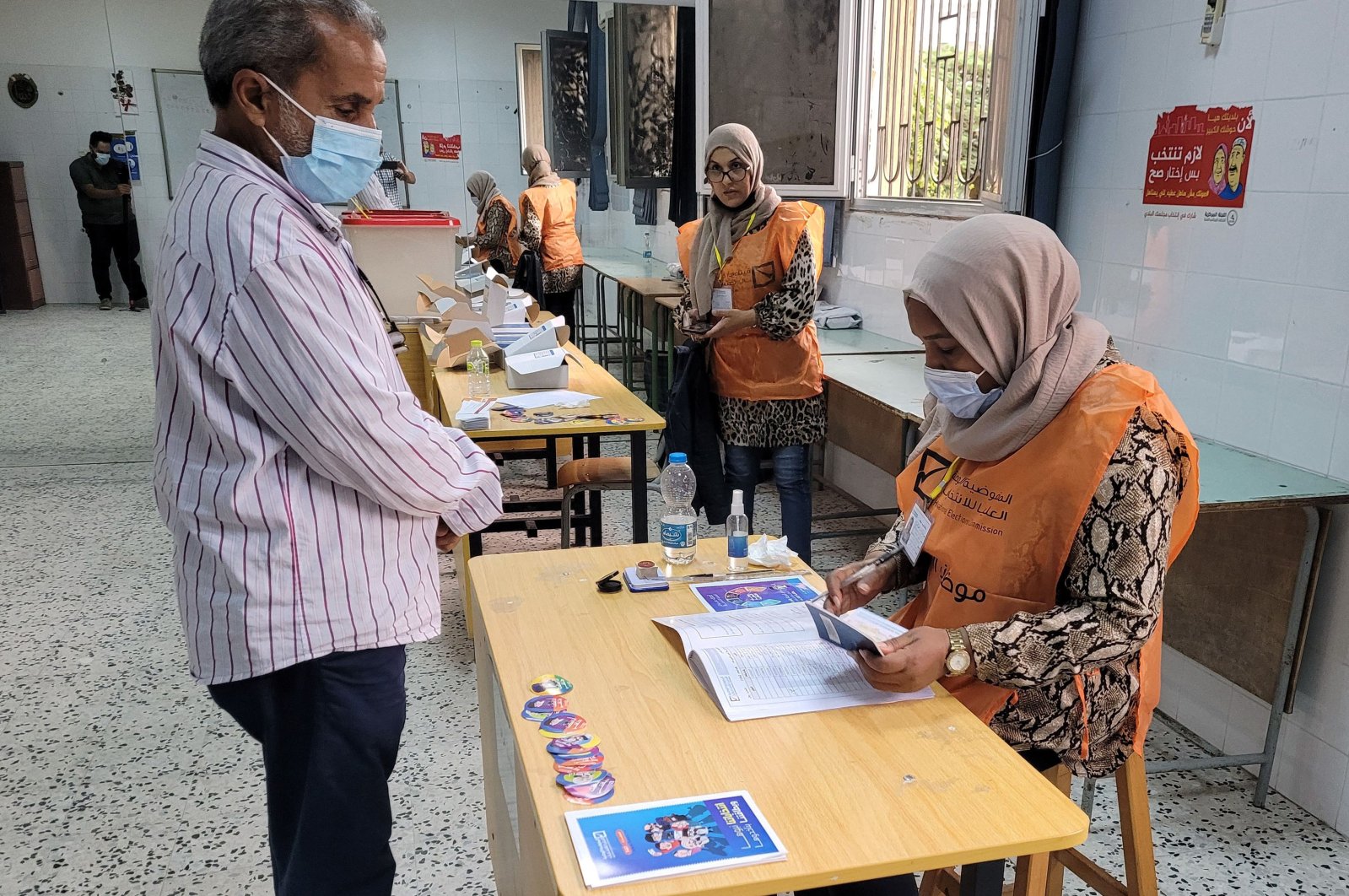 A Libyan man registers to vote inside a polling station in Tripoli, Libya, Nov. 8, 2021. (AFP Photo)