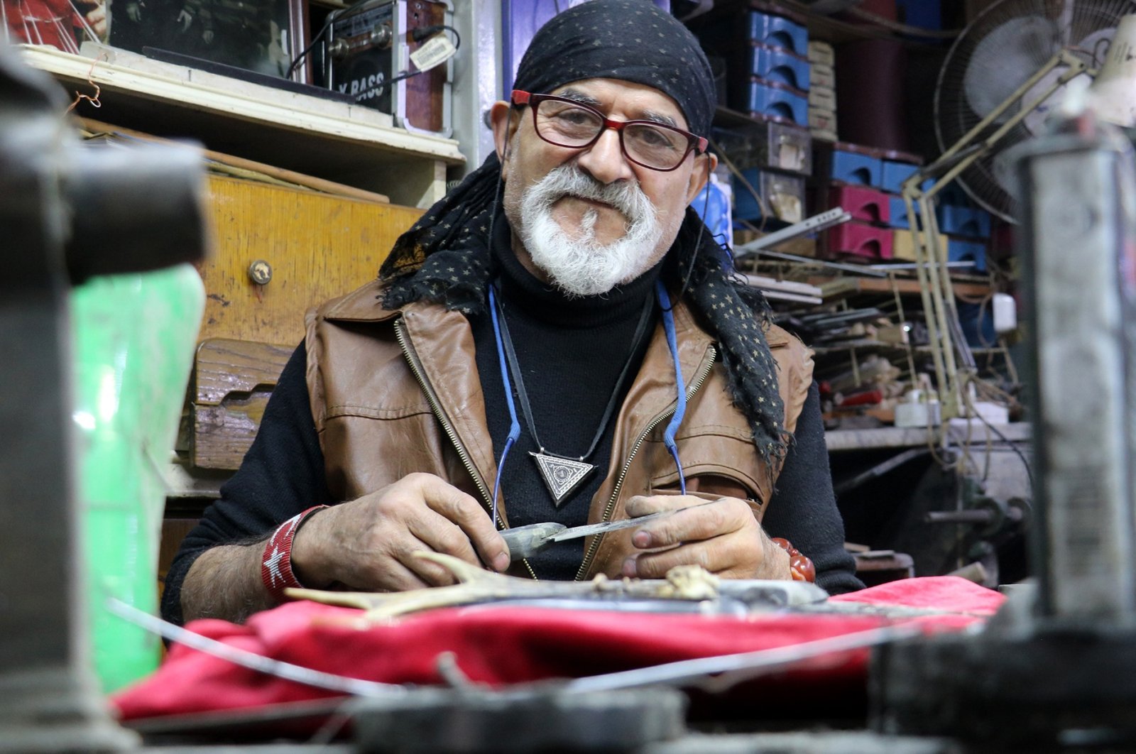Erdoğan Güzel, maker of world's smallest knives, poses for a photo in his workshop, in Sivas, Turkey, Nov. 10, 2021. (IHA Photo)