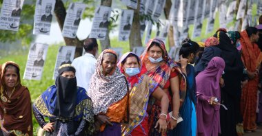 Voters wait in line outside a polling centre in Srinagar, Munshiganj district, Bangladesh, Nov. 11, 2021. (AP Photo)