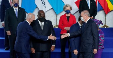 U.S. President Joe Biden (L) reaches out to shake hands with President Recep Tayyip Erdoğan prior to a family photo during the G-20 leaders' summit in Rome, Italy, Oct. 30, 2021. (AFP Photo)