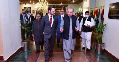 This handout photo taken and released by Pakistan's Ministry of Foreign Affairs on Nov. 11, 2021, shows Pakistan's Foreign Minister Shah Mahmood Qureshi (R) talking with U.S. Special Representative to Afghanistan, Thomas West (L), as they arrive to attend the "troika plus" meeting on Afghanistan, in Islamabad, Pakistan. (Photo by Pakistan's Ministry of Foreign Affairs / AFP)