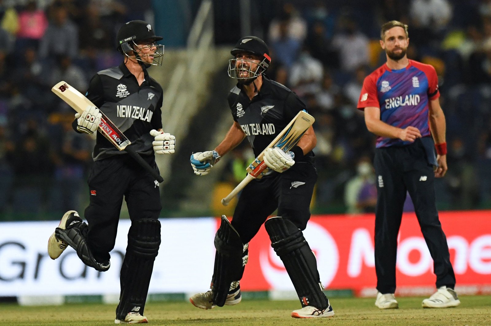 New Zealand's Daryl Mitchell (C) reacts after New Zealand's victory at the end of the ICC men's T20 World Cup semifinal against England in Abu Dhabi, Nov. 10, 2021. (AFP Photo)