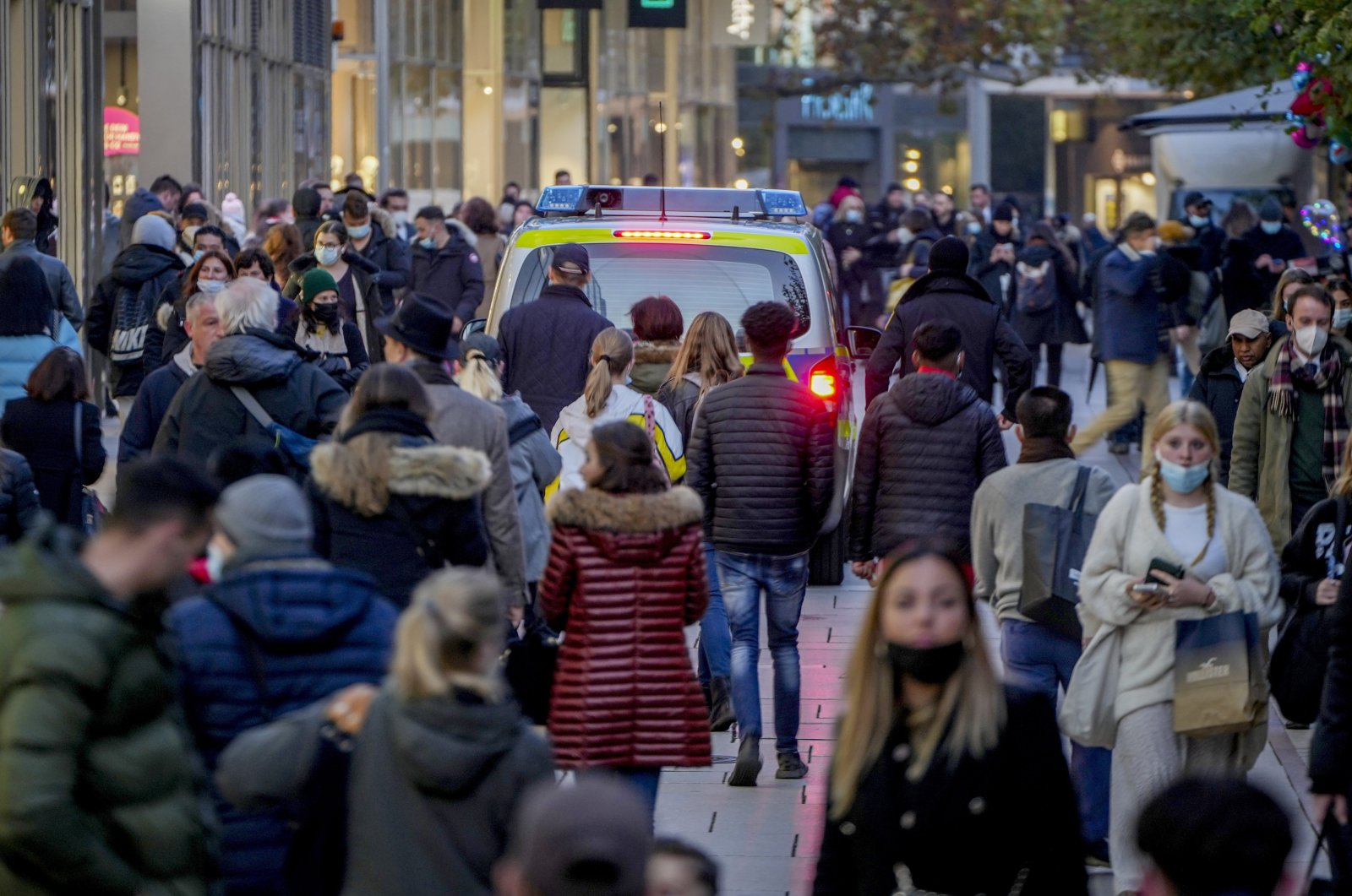 A police car patrols through the main shopping street in Frankfurt, Germany, Nov. 10, 2021. (AP Photo)