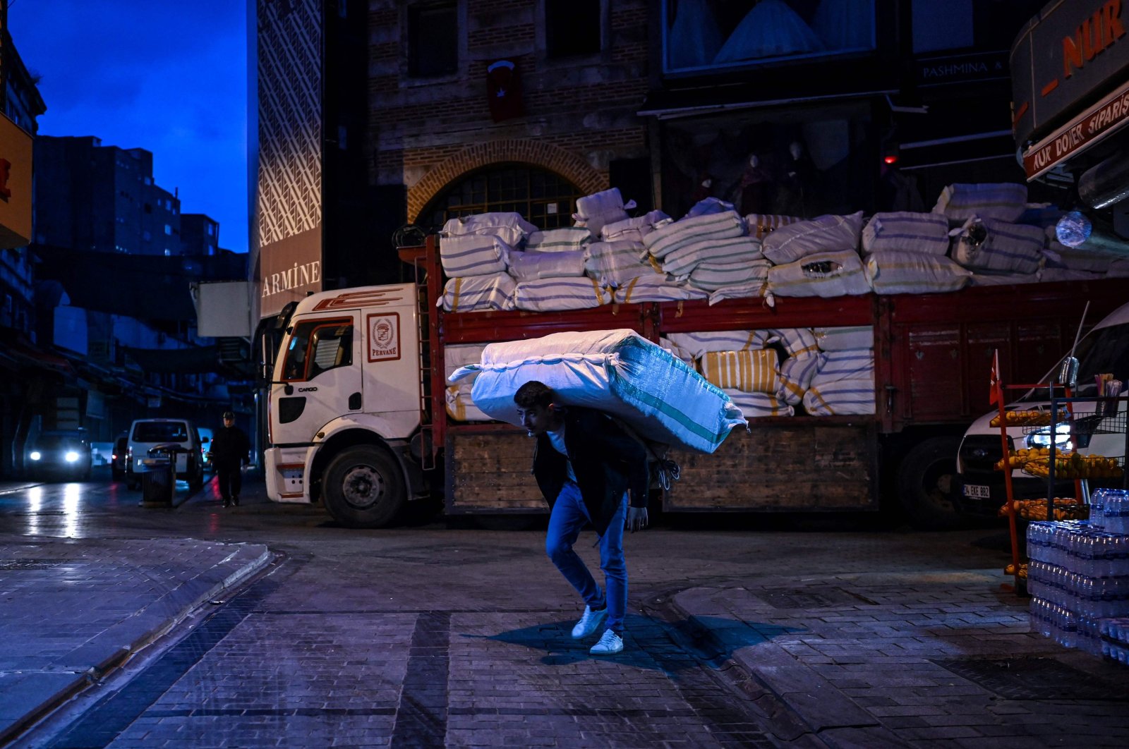 A porter carries belongings on a street near the Grand Bazaar in Istanbul, Turkey, Oct. 28, 2021. (AFP Photo)