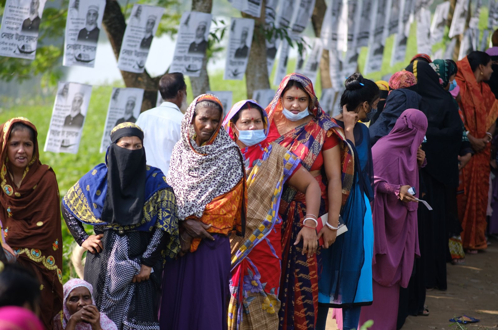 Voters wait in line outside a polling centre in Srinagar, Munshiganj district, Bangladesh, Nov. 11, 2021. (AP Photo)