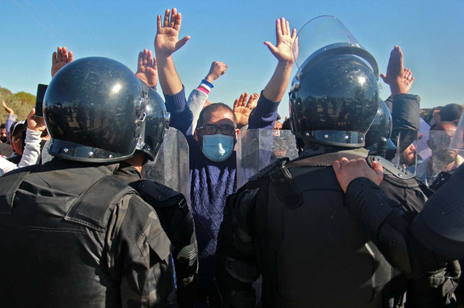 Members of the security forces face Tunisian anti-government demonstrators during a general strike following the reopening of a rubbish dump, in the central region of Sfax, which has seen weeks of angry demonstrations over a growing waste crisis, Aguereb, Tunisia, Nov. 10, 2021. (AFP Photo)