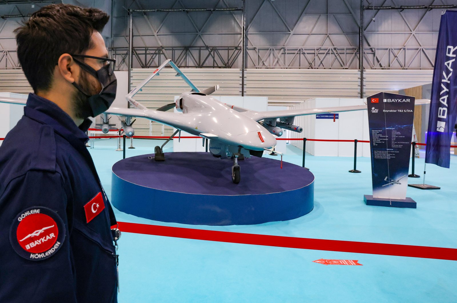 An engineer from Turkish drone-maker Baykar stands next to a TB2 drone during the first day of SAHA EXPO Defence & Aerospace Exhibition in Istanbul, Turkey, Nov. 10, 2021. (Reuters Photo)