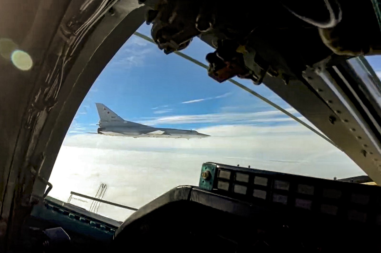 In this handout photo taken from a video released by the Russian Defense Ministry Press Service on Wednesday, a long-range Tu-22M3 bomber of the Russian Aerospace Forces flies to patrol the airspace of Belarus, Nov. 11, 2021. (AP Photo)