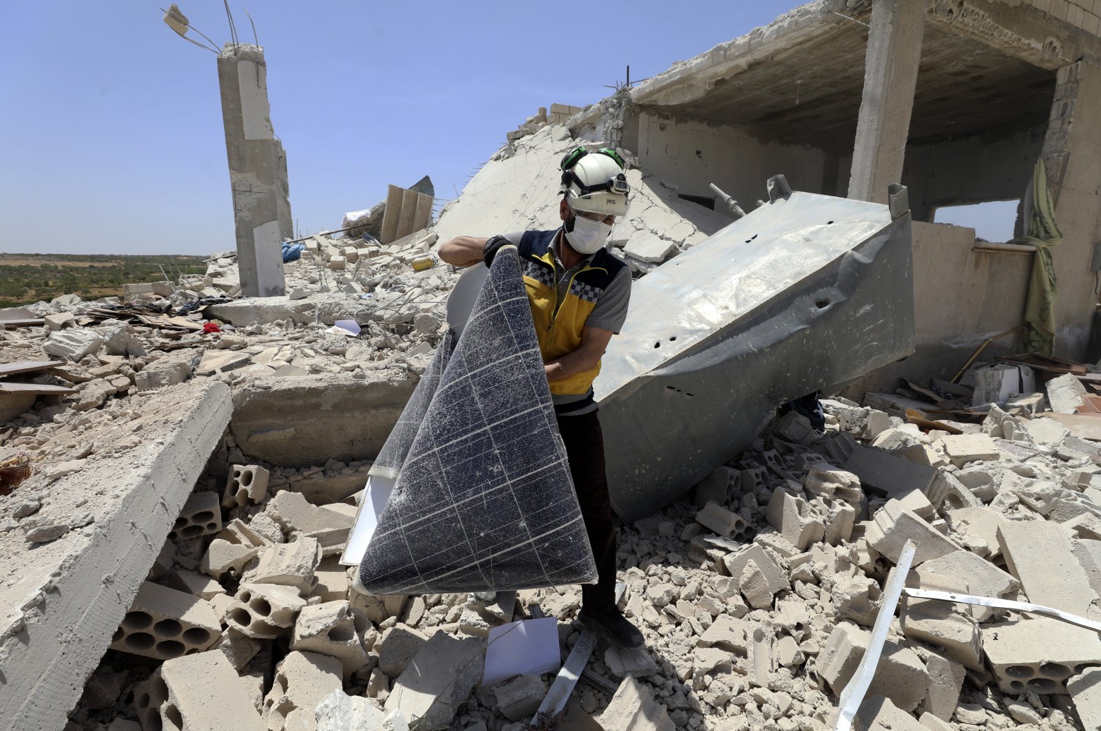 A civil defense worker inspects a damage house after shelling hit the town of Ibleen, a village in southern Idlib province, Syria, July 3, 2021. (AP File Photo)
