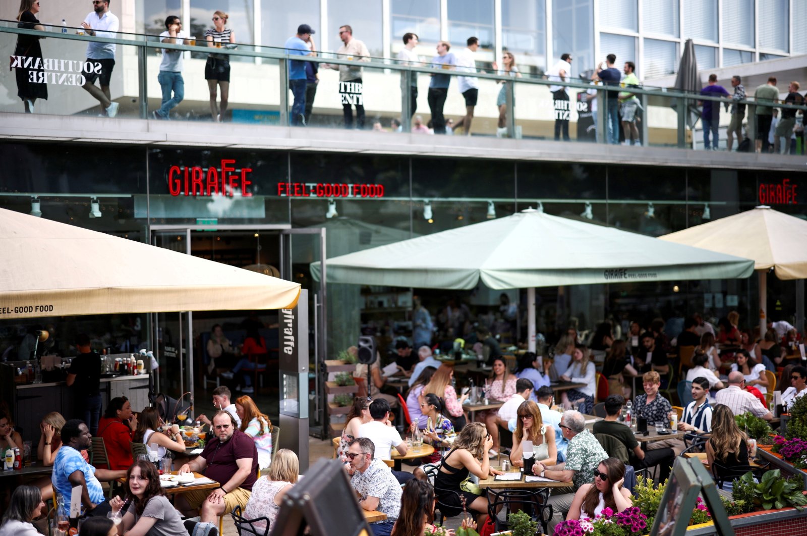 People sit at an outdoor restaurant on South Bank during sunny weather, amid the coronavirus outbreak, London, Britain, June 5, 2021. (Reuters Photo)