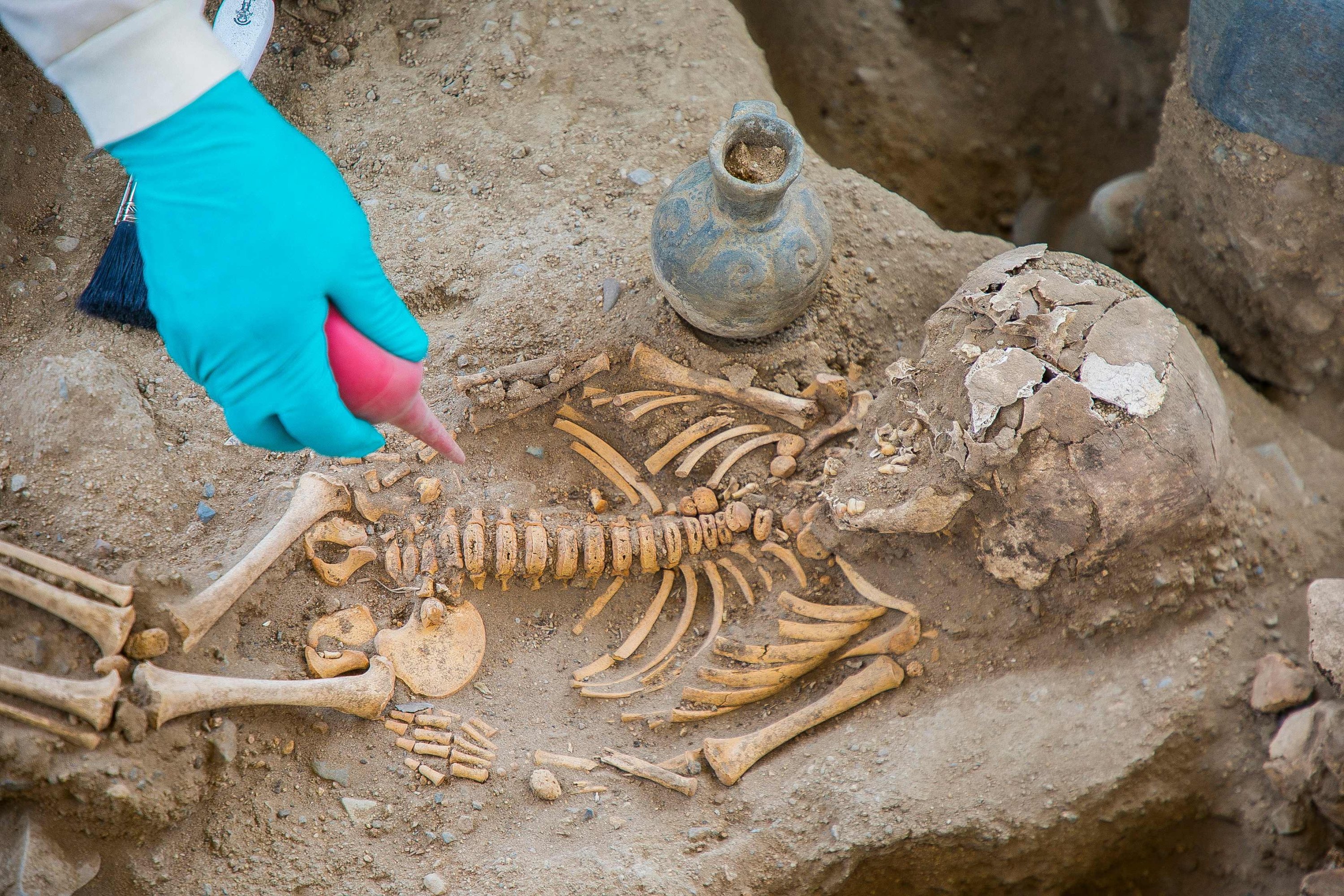 Handout picture released by Peruvian Ministry of Culture shows people working at the archaeological complex of Chan Chan following the discovery of a tomb with 25 human remains, in Trujillo, Peru, Nov. 11, 2021. (AFP)