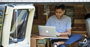 U.S. journalist Danny Fenster works out of his van that he turned into a home office in Detroit, U.S., 2018. (AP Photo)