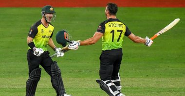Australia's Marcus Stoinis (R) and Matthew Wade celebrate their victory at the end of the ICC men's T20 World Cup semifinal match against Pakistan in Dubai, UAE, Nov. 11, 2021. (AFP Photo)