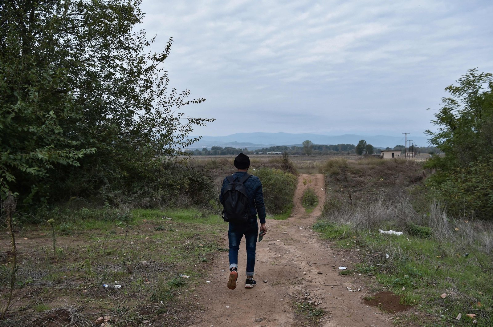 A migrant walks on a road near Idomeni at the border between Greece and North Macedonia, Oct. 18, 2021. (AFP Photo)