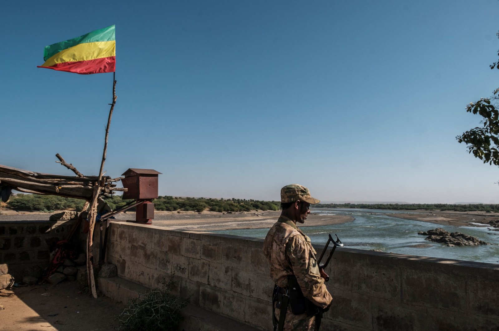 A member of the Amhara Special Forces watches on at the border crossing with Eritrea where an outdated Ethiopian flag waves, in Humera, Ethiopia, Nov. 22, 2020. (AFP)
