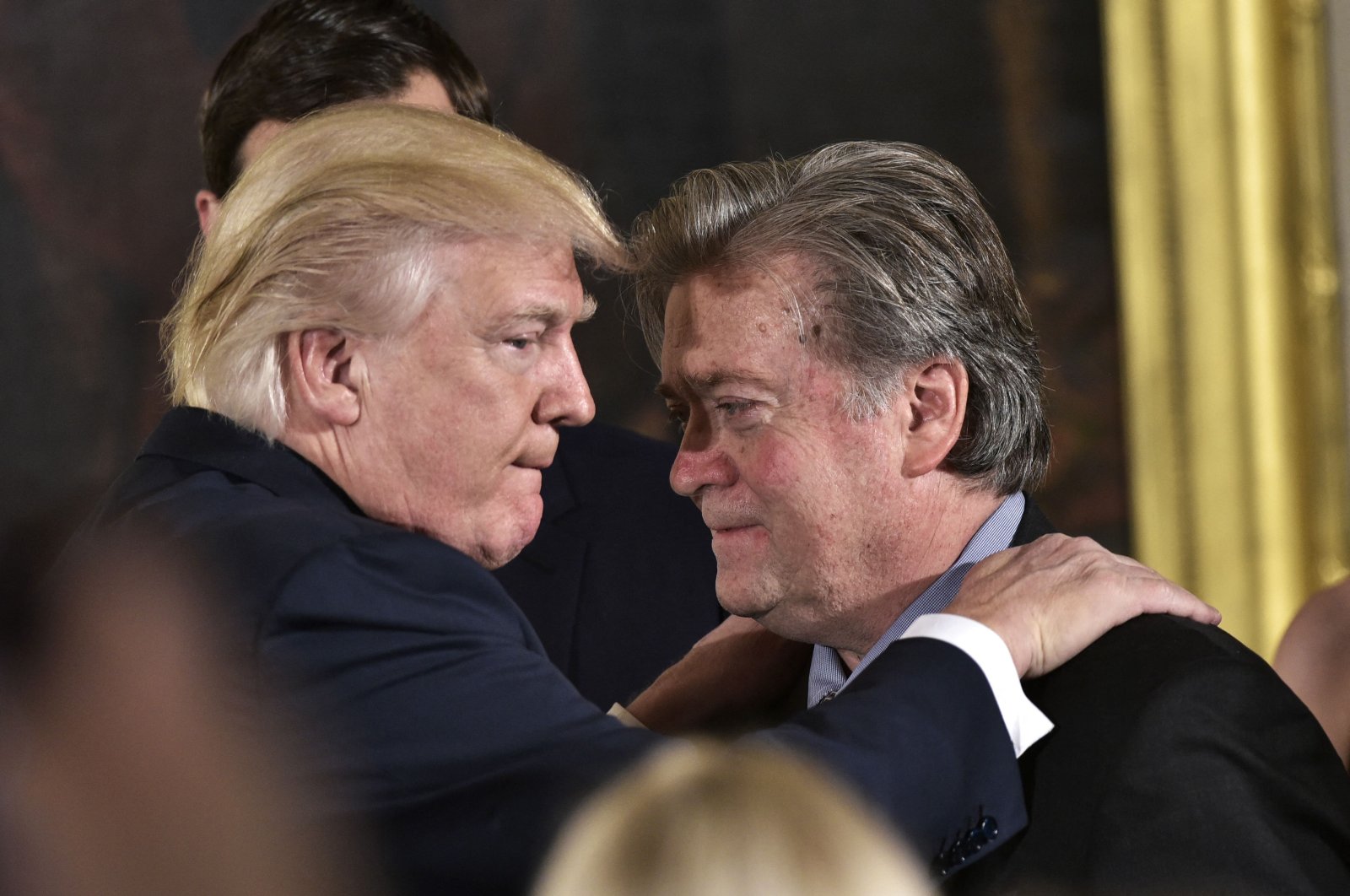 Then-U.S. President Donald Trump (L) congratulates Senior Counselor to the President Stephen Bannon during the swearing-in of senior staff in the East Room of the White House in Washington, D.C., Jan. 22, 2017. (AFP)