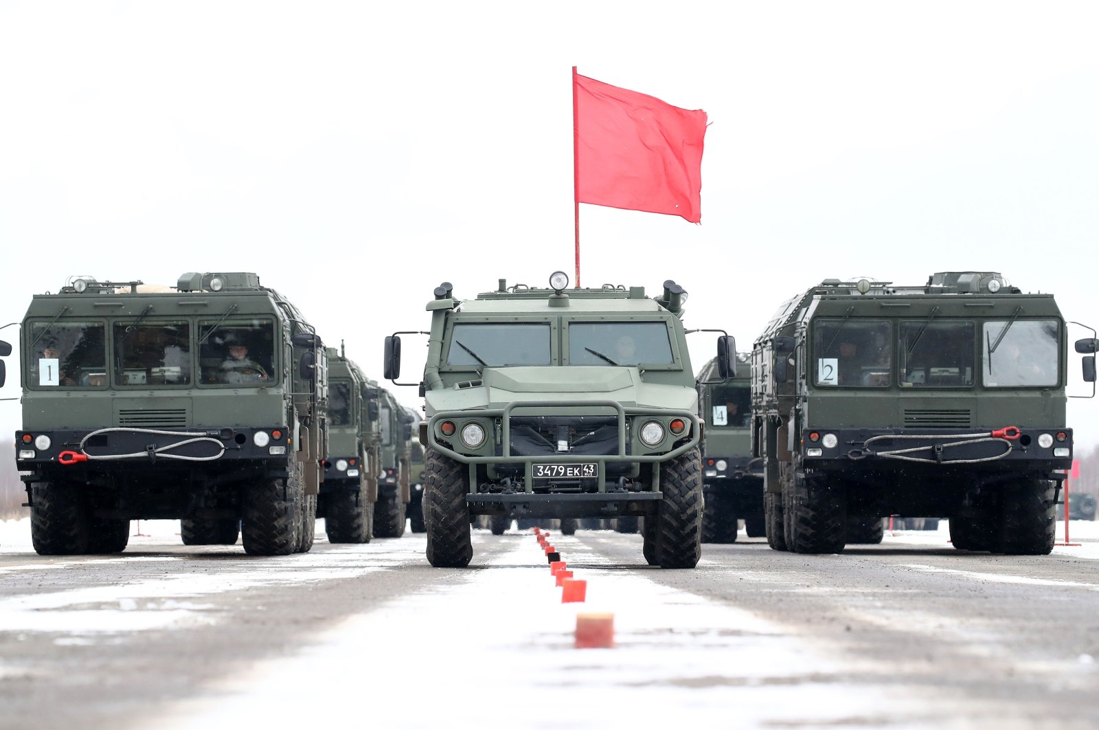 GAZ Tigr all-terrain infantry mobility vehicles (C) and Iskander-M mobile short-range ballistic missile systems of the Russian Army St. Petersburg Garrison are seen on Gorelovo Airfield during a rehearsal for the forthcoming 9 May Victory Day parade, March 19, 2021. (Reuters Photo)