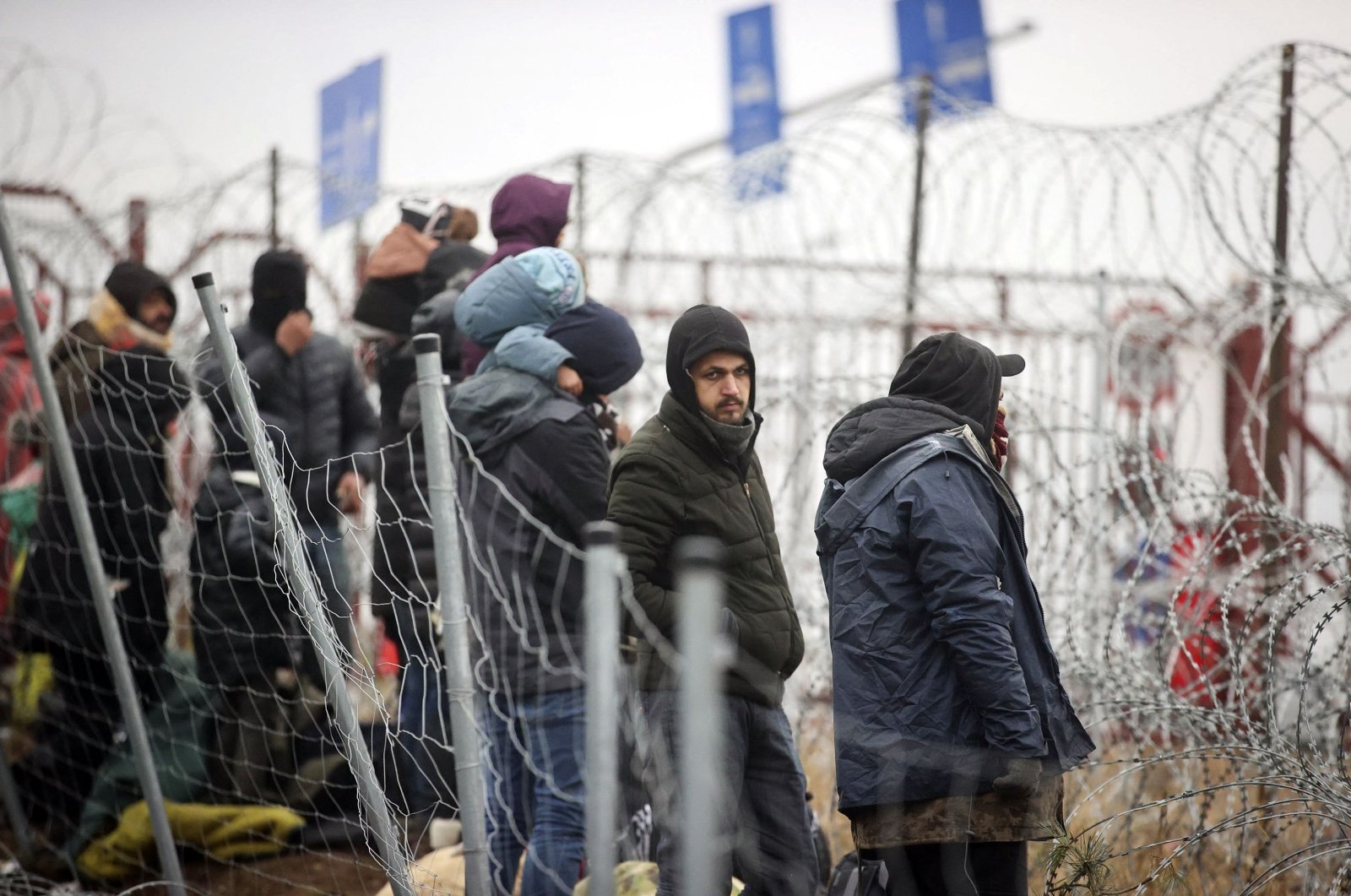 A group of migrants is seen near the Belarusian-Polish border in the Grodno region, Belarus, Nov. 13, 2021. (Leonid Shcheglov / BELTA via AFP)