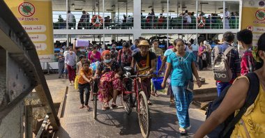 People disembark from a ferry at the Pansodan jetty in Yangon, Myanmar, Nov. 12, 2021. (AP Photo)