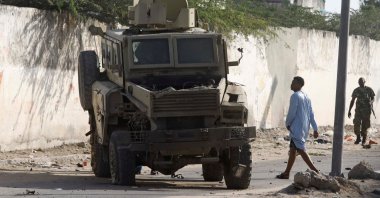 A civilian looks at a destroyed armoured Personnel Carriers (APC) at the scene of a suicide explosion targeting the African Union Mission in Somalia (AMISOM) convoy in Mogadishu, Somalia. Nov. 11, 2021. (Reuters Photo) 