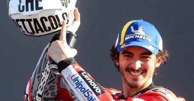 Ducati Lenovo Team Italian rider Francesco Bagnaia celebrates on the podium with a helmet of Italian rider Valentino Rossi, after winning the MotoGP race of the Valencia Grand Prix at the Ricardo Tormo racetrack in Cheste, Spain, Nov. 14, 2021.