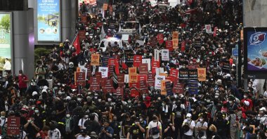 Anti-government protesters hold banners calling for the monarchy reform marching to the German embassy in Bangkok, Thailand, Nov. 14, 2021. (AP Photo)