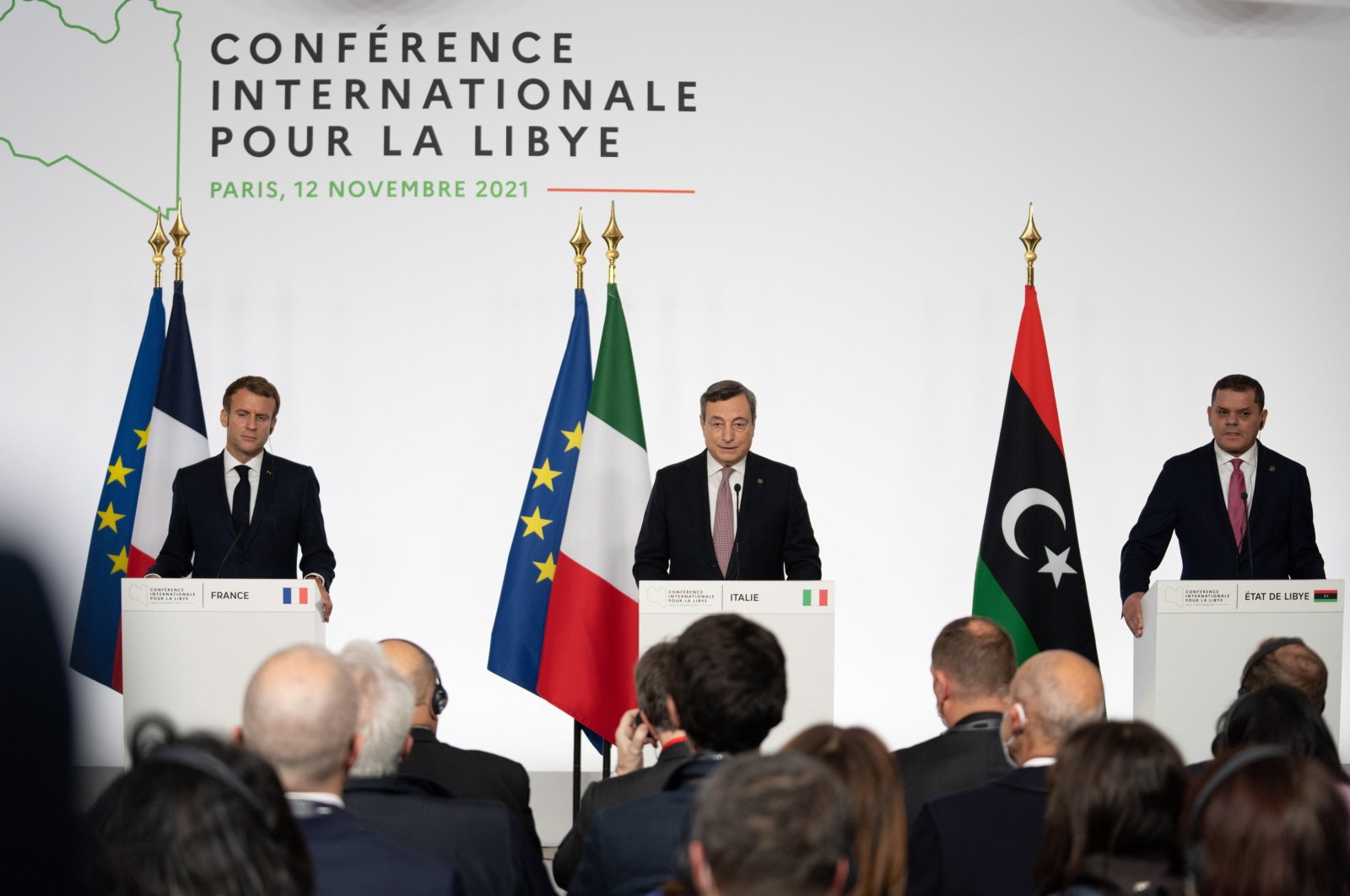 (L-R) French President Emmanuel Macron, Italian Prime Minister Mario Draghi and Libyan Prime Minister Abdul Hamid Dbeibah participate in the press conference at the end of the International Conference on Libya at La Maison de la Chimie in Paris, France, 12 November 2021.  (EPA Photo)