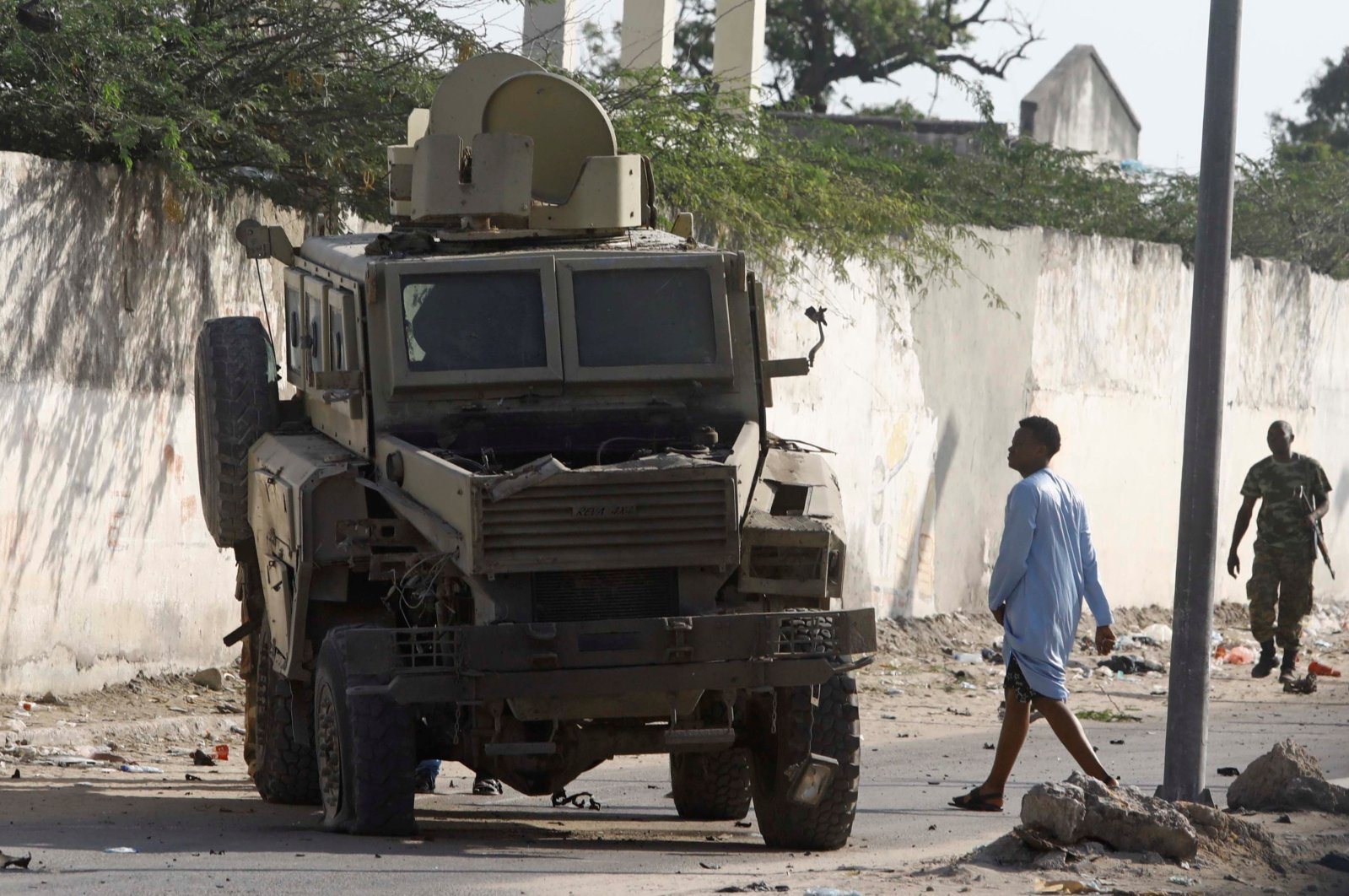 A civilian looks at a destroyed armoured Personnel Carriers (APC) at the scene of a suicide explosion targeting the African Union Mission in Somalia (AMISOM) convoy in Mogadishu, Somalia. Nov. 11, 2021. (Reuters Photo) 