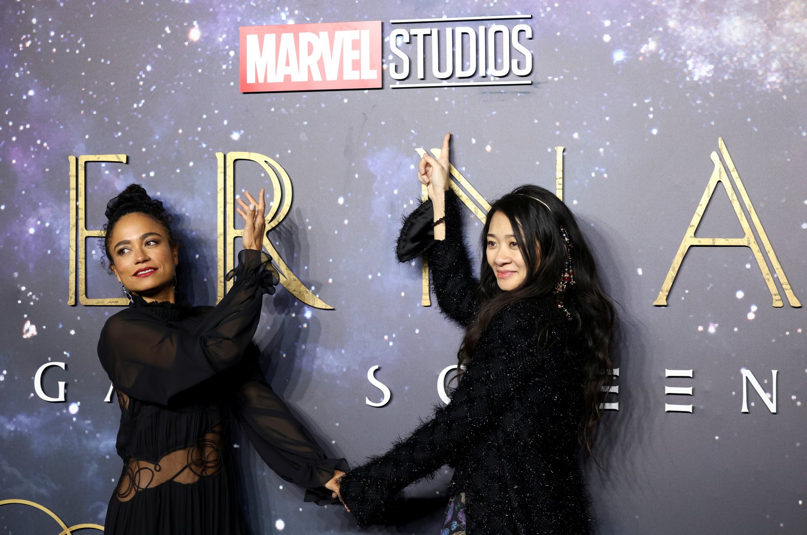 Director Chloe Zhao (R) and cast member Lauren Ridloff pose as they arrive for a screening of the film "Eternals" in London, U.K., Oct. 27, 2021. (Reuters Photo)