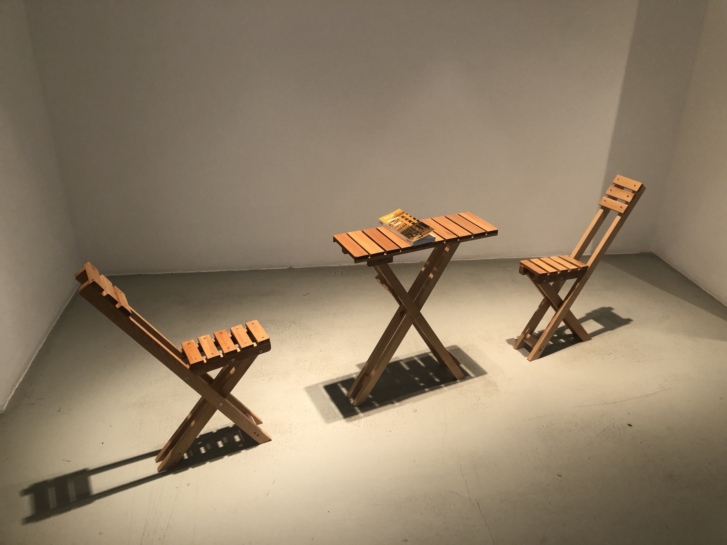 Egemen Tuncer and Hacer Kıroğlu, “Balcony.rar”, installation, wooden folding table and chair, book, 2021. (Photo by Matt Hanson)
