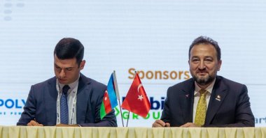 MÜSIAD General Manager Mahmut Asmalı (R) and KOBIA head Orxan Memmedov sign an agreement on a joint road map as part of the International Business Forum, Baku, Azerbaijan, Nov. 15, 2021. (Photo courtesy of KOBIA)